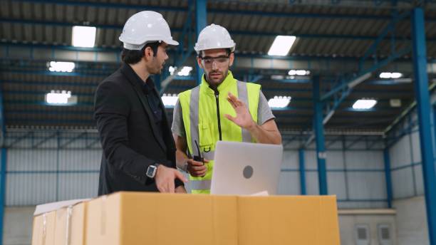 istock Two factory workers working and discussing manufacturing plan in the factory . 1290154159