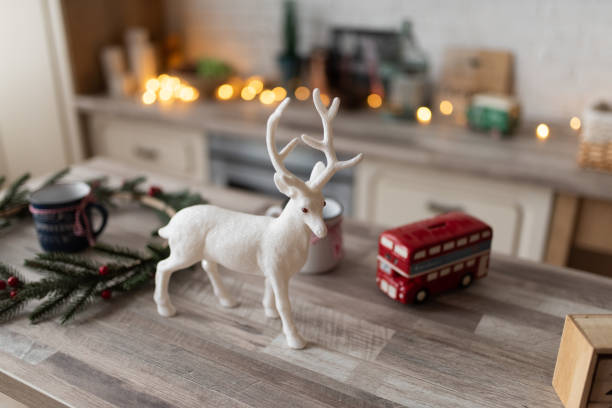istock A decorative deer stands on a table in a Scandinavian kitchen. The kitchen is decorated before Christmas. 1290156030