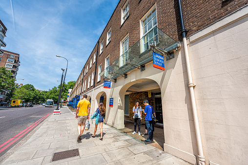 London, UK - June 24, 2018: Entrance to London Business School university college sign with people students standing by gift store shop in summer at Park road street in City of Westminster