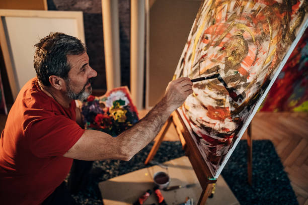 istock Mature male painter working in his art studio 1290156460