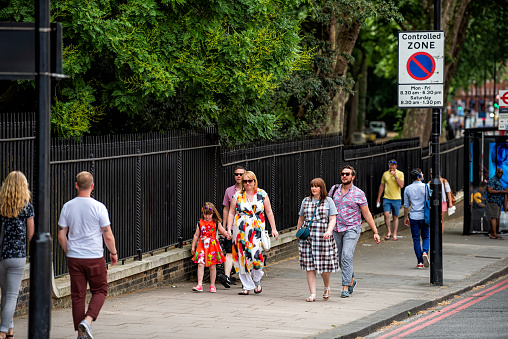 London, UK - June 23, 2018: Chelsea Bridge road street by Lister Hospital bus stop with people walking in summer by controlled zone no waiting traffic sign in Kensington