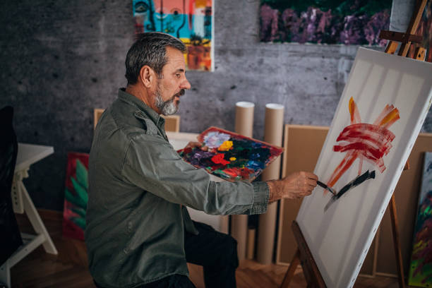 istock Male painter painting in his art studio 1290156605