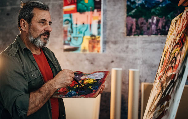 istock Male painter painting in his art studio 1290156613