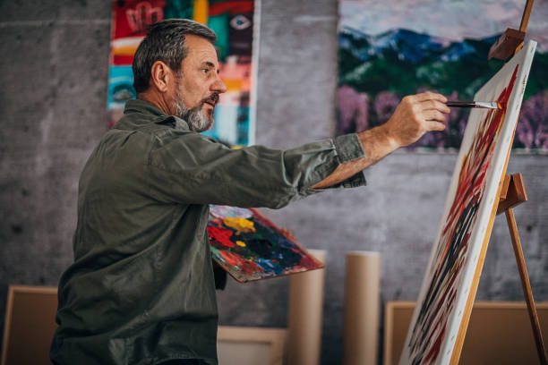 istock Male painter painting in his art studio 1290156674
