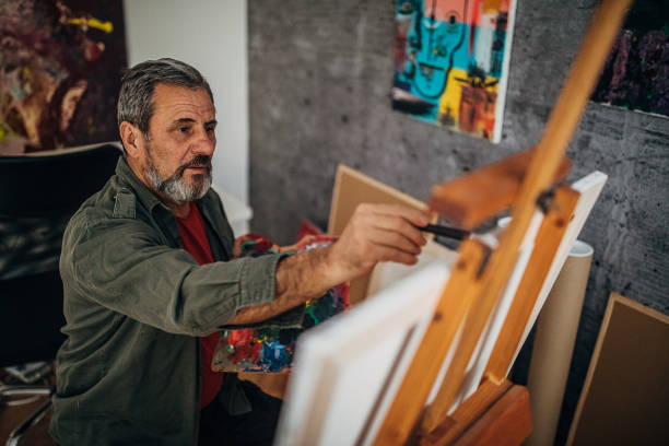 istock Male painter painting in his art studio 1290157311