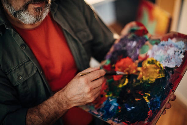 istock Male painter holding artist's palette 1290157506