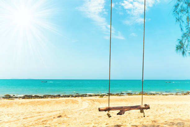 istock Swing on sand beach at tropical island 1290158707