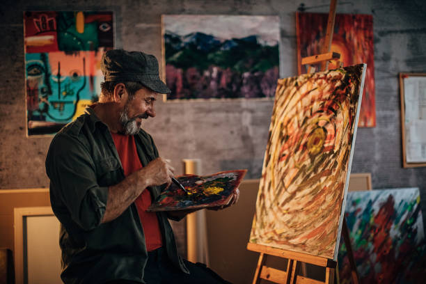 istock One senior painter painting late into the night in his home studio 1290160695
