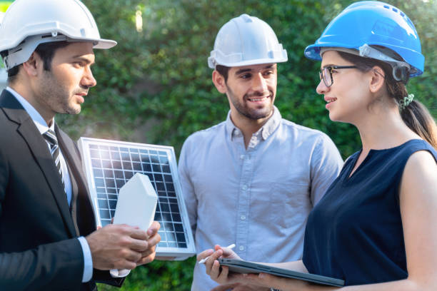 istock Business Engineers Meeting Innovative More Efficient Solar Panel Battery Concept of Renewable Energy Working. Specialists Gathered for Outdoor testing Photovoltaic cells module. 1290161208