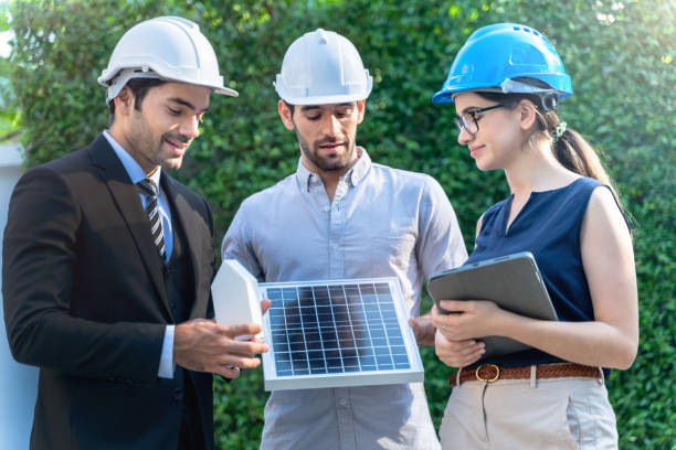 istock Business Engineers Meeting Innovative More Efficient Solar Panel Battery Concept of Renewable Energy Working. Specialists Gathered for Outdoor testing Photovoltaic cells module. 1290161736