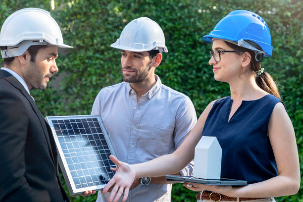istock Business Engineers Meeting Innovative More Efficient Solar Panel Battery Concept of Renewable Energy Working. Specialists Gathered for Outdoor testing Photovoltaic cells module. 1290161790