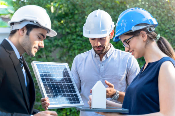 istock Business Engineers Meeting Innovative More Efficient Solar Panel Battery Concept of Renewable Energy Working. Specialists Gathered for Outdoor testing Photovoltaic cells module. 1290161849