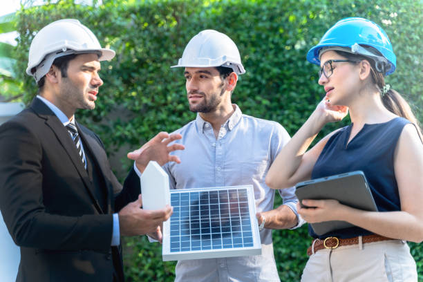 istock Business Engineers Meeting Innovative More Efficient Solar Panel Battery Concept of Renewable Energy Working. Specialists Gathered for Outdoor testing Photovoltaic cells module. 1290161880