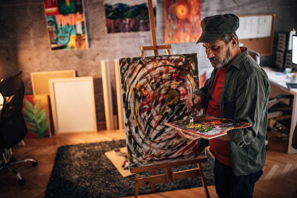 istock Painter painting late into the night in his studio 1290162247