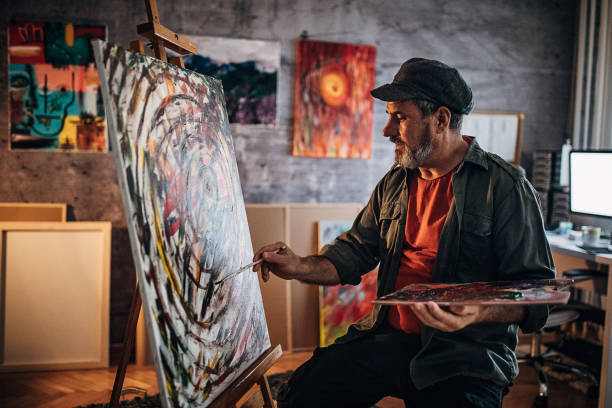 istock Senior man painting in his studio 1290163832
