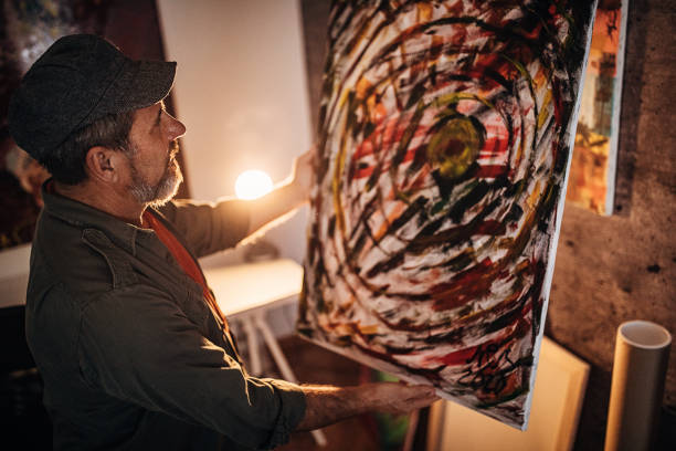 istock One artist looking with satisfaction in his finished paint 1290164197