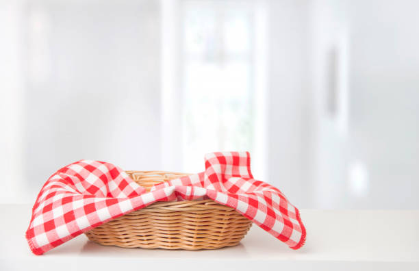 istock Wicker basket with red checkered tablecloth on the table 1290164319