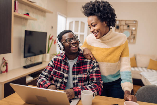 istock Happy man working and enjoying with his girlfriend at home office 1290165930