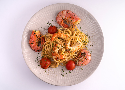 a plate with spaghetti and prawns