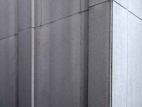 grey concrete architectural corner building detail with geometric panels
