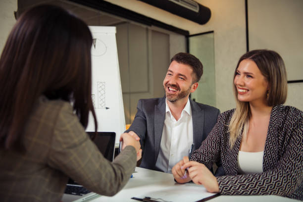 istock Successful businessman shaking hands with female client 1290169691