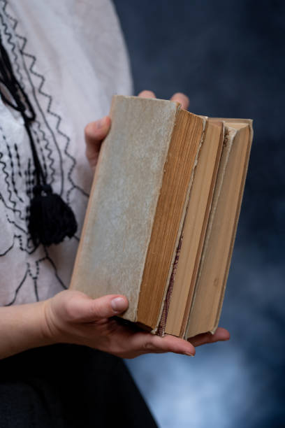 istock Closeup of Hands Holding A Stack Of Books. Concept of self-development during self-isolation 1290170820