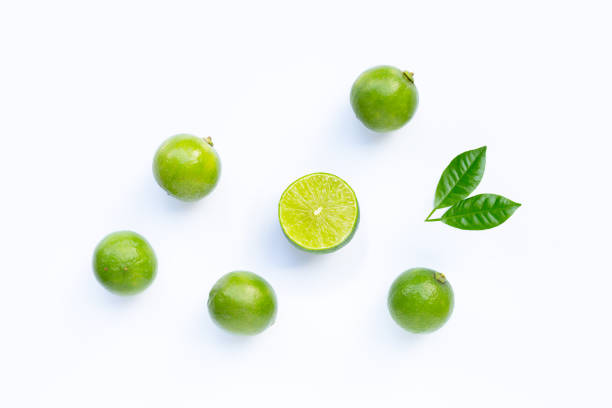 istock Limes with leaves isolated on white. 1290172437
