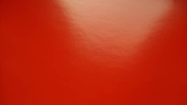 Beautiful bright red background. Closeup sheet of shiny reflecting incident light paper. Pure fun color. Intense shade of red, close to scarlet or blood color with high reflectivity. Beautiful bright red background. Closeup sheet of shiny reflecting incident light paper. Pure fun color. Intense shade of red, close to scarlet or blood color with high reflectivity reflectivity stock pictures, royalty-free photos & images