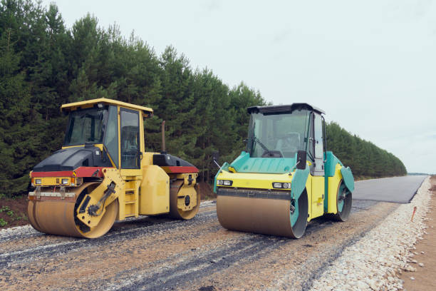 istock Special road vehicles. Compactor At Road Compaction Works. A roller compacting asphalt on a road 1290179864