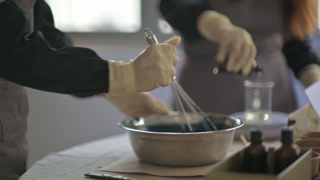 asian chinese teenage boy learning the soap making process from female artist