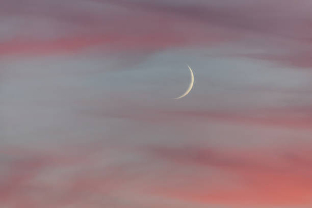 istock Moon crescent at dusk in november. Red clouds at sunset. 1290188108
