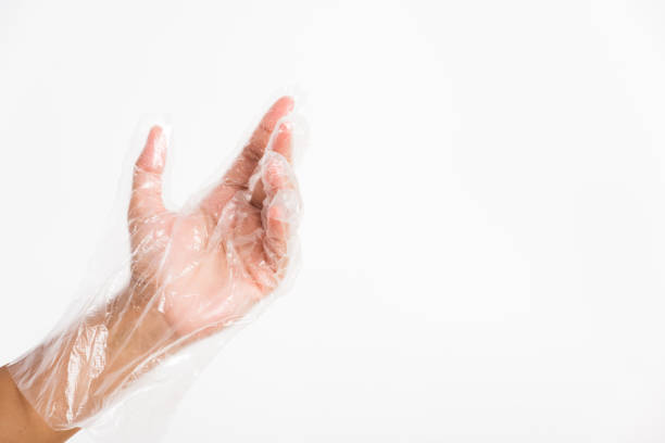 istock Woman hand wearing single use protect disposable transparent plastic glove 1290189200