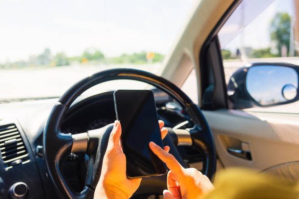 istock woman inside a car and using touch screen on mobile smartphone 1290189217