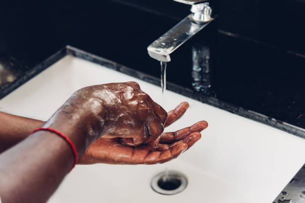 istock man hands rubbing with soap and water in sinks 1290189583