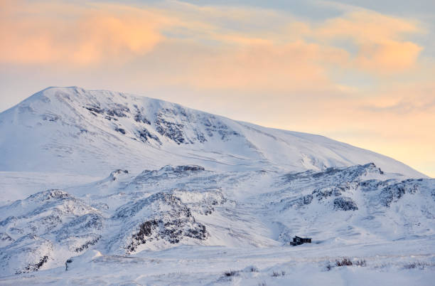 istock Snowy mountain against sundown sky 1290190095