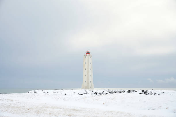istock Lighthouse on showy shore near sea 1290190627