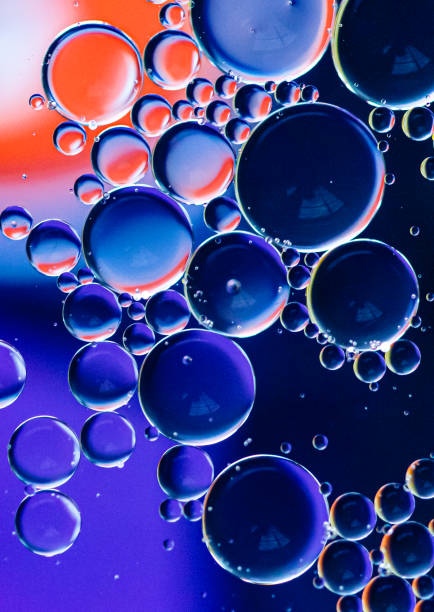 istock Abstract macro image of colorful oil drop circles in water. 1290190694