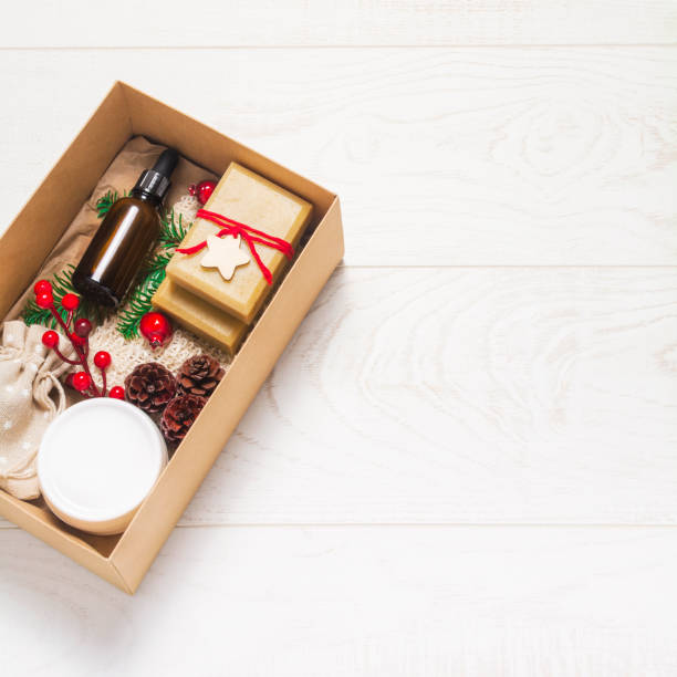 istock Christmas box with cosmetic on wooden background 1290198393