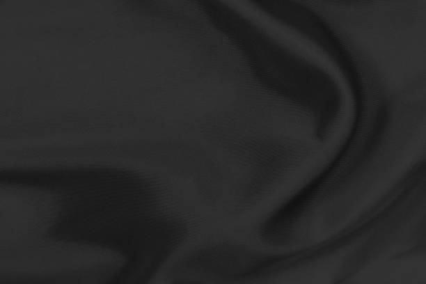 istock Smooth elegant black silk fabric or satin luxury cloth texture can use as wedding background. for drapery luxurious abstract design 1290198558