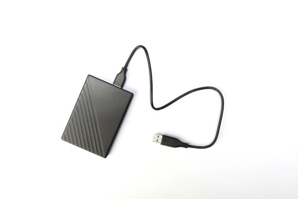 istock Hard drive or HDD on white. external hard drive for storing memory with wire 1290205169