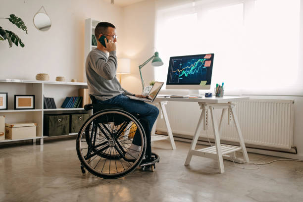 istock Young man with disabilities working on his stock market portfolio 1290205921