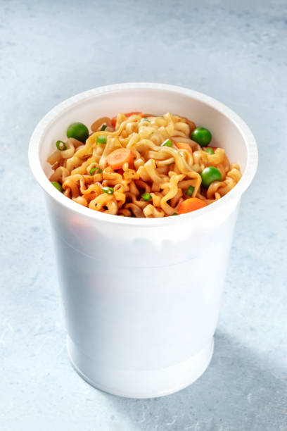 istock Noodles in a plastic cup. Ramen soba with vegetables 1290208361