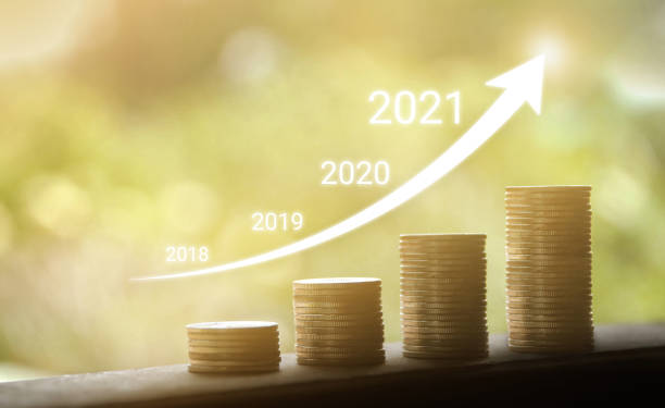 istock Growth in 2021 year concept. Business graph with arrow up. Growing money coins stack. 1290211566