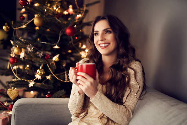 istock Young woman relaxing on couch during christmas 1290216056