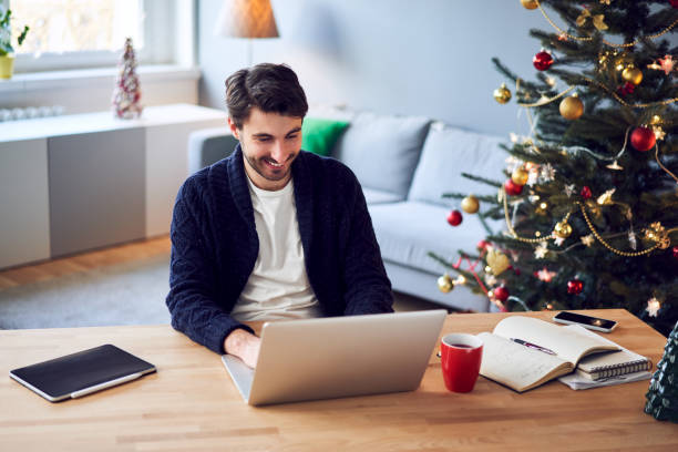 istock Smiling man working from home during Christmas 1290216170