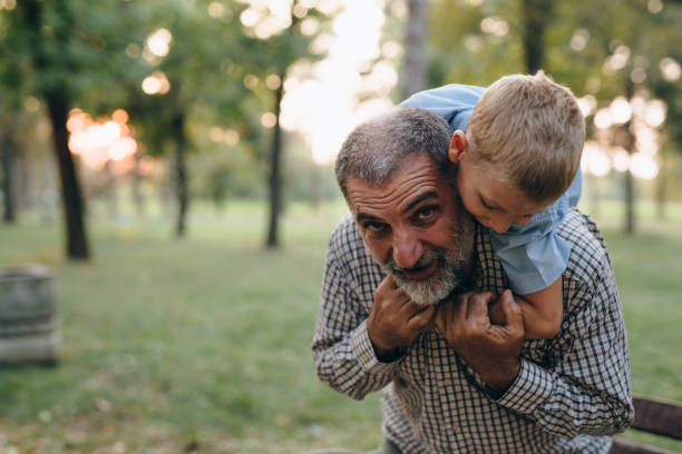 istock grandfather spending time with grandson in public park 1290218399
