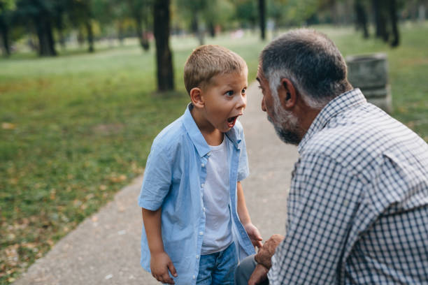 istock grandfather spending time with grandson in public park 1290218522