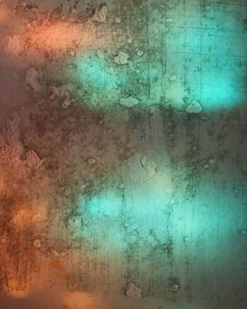 istock Vertical concrete background. Texture surface with turquoise and orange light spots 1290222039