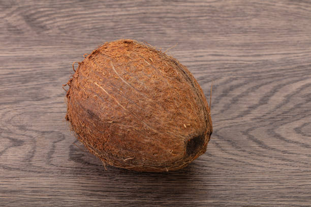 istock Tropical brown coconut over background 1290222674