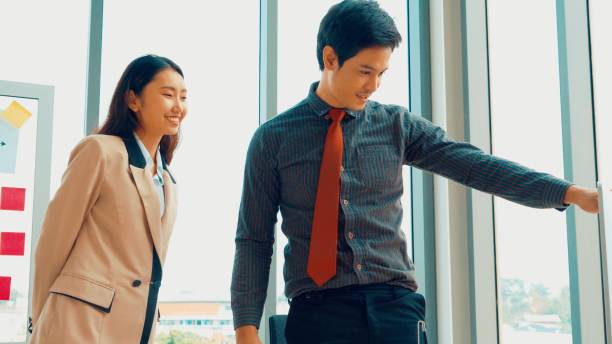 istock Two business people talk project strategy at office 1290222897